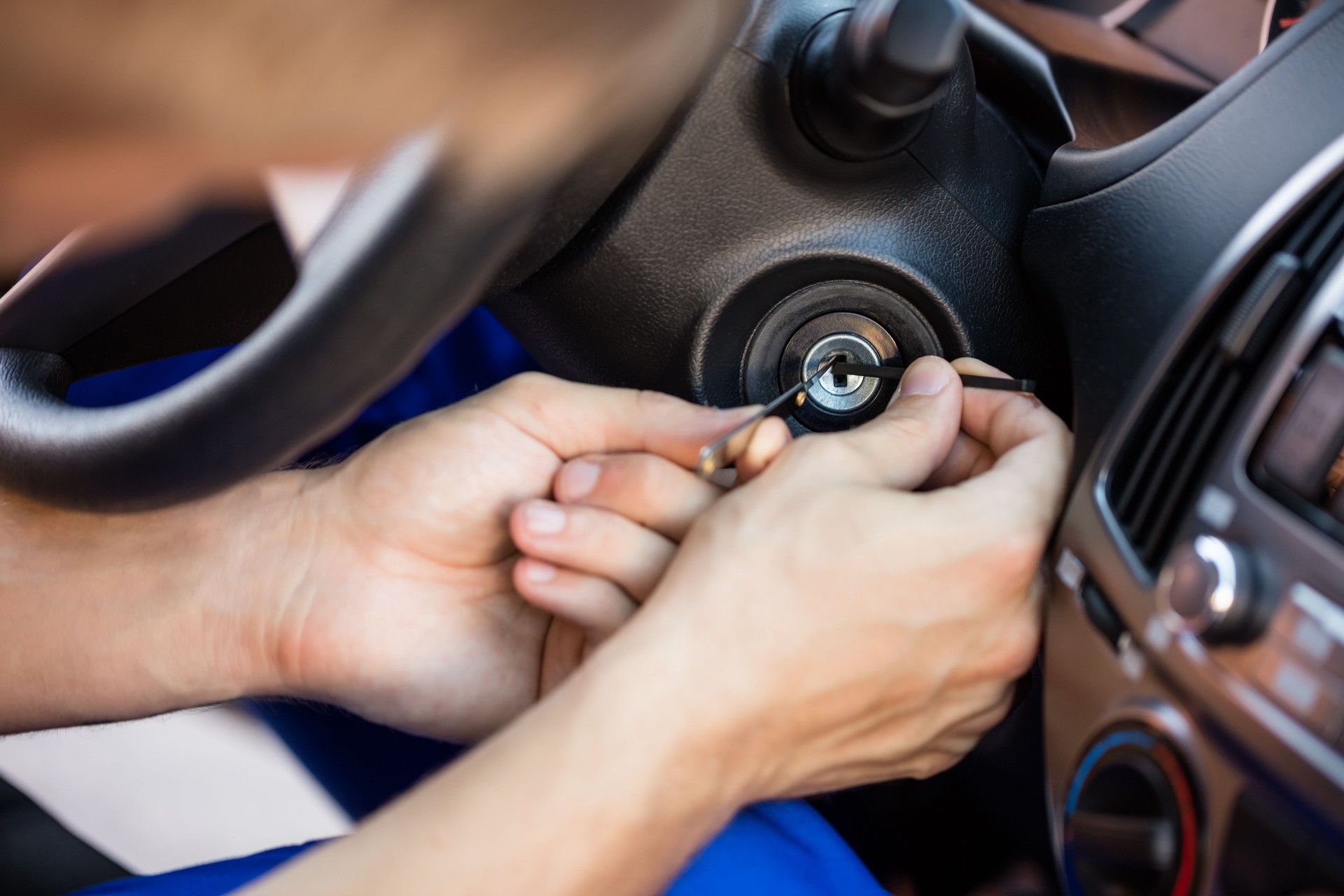 Person Inserting Tool In Key Hole